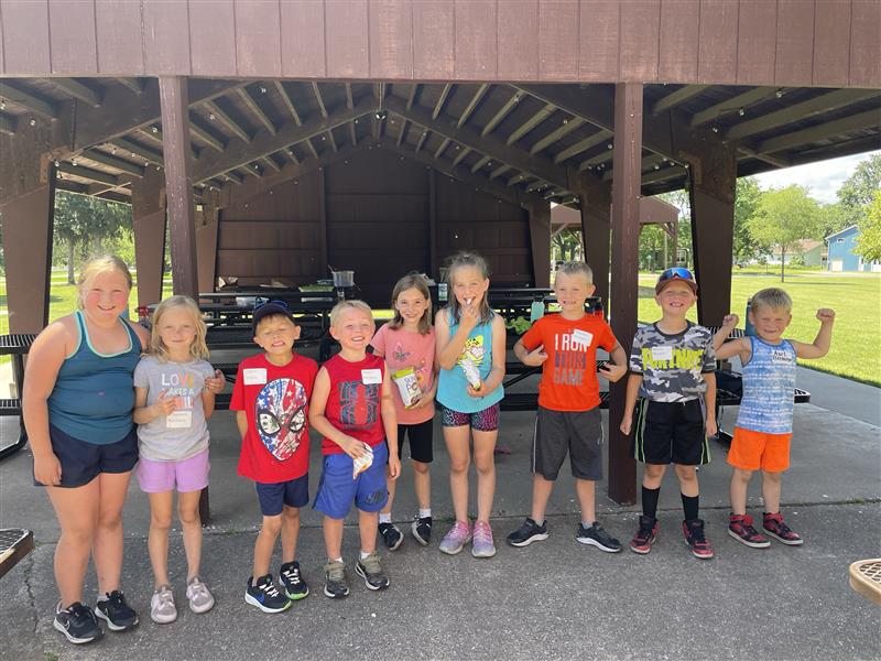 little kids standing together for a group picture at a day camp