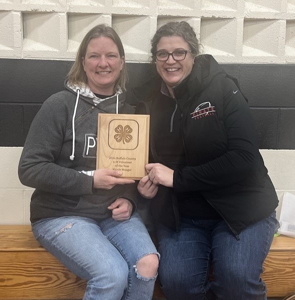 Picture Annie L. presenting Nicole H. with the Volunteer of the year award.